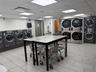 Communal laundry room with stacked washer / dryer and washing machine and clothes dryer