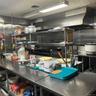 Fully equipped professional kitchen with working deep freezers, refrigerators, stoves, ovens, cooking supplies, etc.