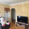 Rear Apt's Living Room. Door to primary bedroom pictured as well.