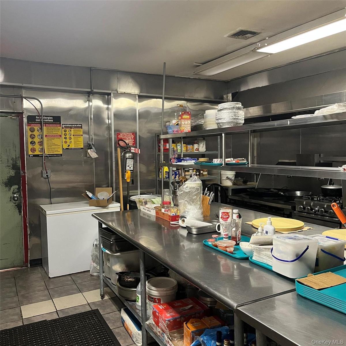 Fully equipped professional kitchen with working deep freezers, refrigerators, stoves, ovens, cooking supplies, etc.
