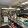 Fully equipped professional kitchen with working deep freezers, refrigerators, stoves, ovens, cooking supplies, etc.