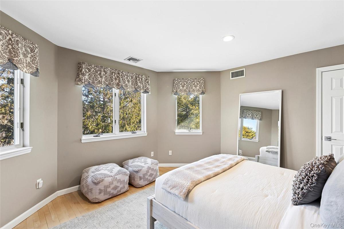 Bedroom with light wood-style flooring, recessed lighting and multiple windows