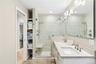 Full spa bath featuring double vanity, and a stall shower