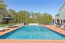 Swimming pool featuring a hot tub and a patio area.  virtually enhanced to show pool without cover.