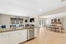 Kitchen featuring dishwasher, white cabinets, light wood-style floors, light stone countertops, and recessed lighting