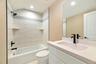 Full bath with washtub / shower combination, vanity, and recessed lighting