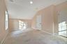 Additional living space featuring baseboards and vaulted ceiling