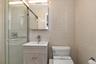 Bathroom with tile walls, vanity, and a shower stall
