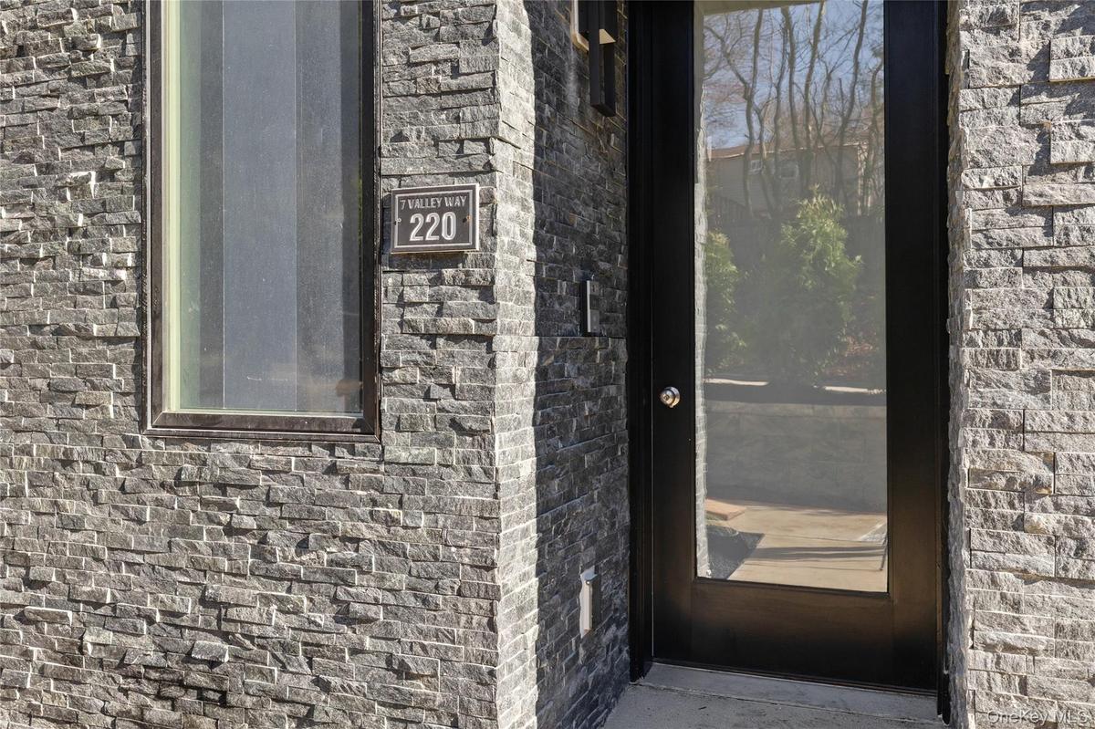 View of exterior entry featuring brick siding