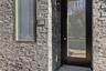 View of exterior entry featuring brick siding