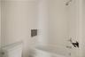 Bathroom featuring tub / shower combination and toilet