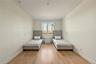 Bedroom with light wood-style floors and baseboards