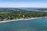 Bird's eye view of unending shoreline and a heavily wooded area