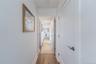 Corridor with baseboards and wood finished floors