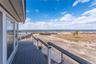 Balcony with a view of the beach and a water view