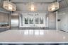 Kitchen featuring gray cabinetry, light countertops, a sink, and appliances with stainless steel finishes