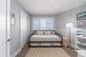 Bedroom with baseboards, wood finished floors, and a closet