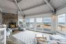Sunroom / solarium featuring beamed ceiling