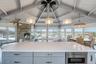 Kitchen featuring lofted ceiling with beams, hanging light fixtures, plenty of natural light, and open floor plan