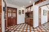 Entryway with a textured wall, light flooring, and baseboards