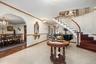 Entrance foyer featuring a chandelier, stairway, baseboards, and crown molding