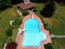 View of pool featuring a water slide, a gazebo, and a lawn