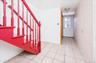Entrance foyer with light tile patterned floors and wallpapered walls; first floorexit to backyard