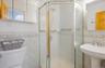 Full primary bathroom with tile walls and a shower stall