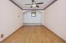 Family room featuring ceiling fan, light wood -type finished floors, and crown molding