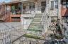 Property entrance featuring a garage and stone siding