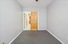 Second bedroom  featuring light carpet and baseboards