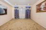 Carpeted third bedroom with baseboards (on first floor)