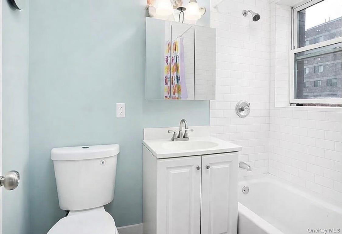Full bath featuring vanity and shower / bath combo with shower curtain