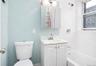 Full bath featuring vanity and shower / bath combo with shower curtain