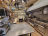 Kitchen with light tile patterned flooring, extractor fan, and open shelves