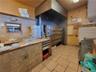 Kitchen featuring tile counters and light tile patterned floors