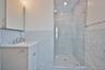 Master bath with tile walls, vanity, a shower stall, and recessed lighting