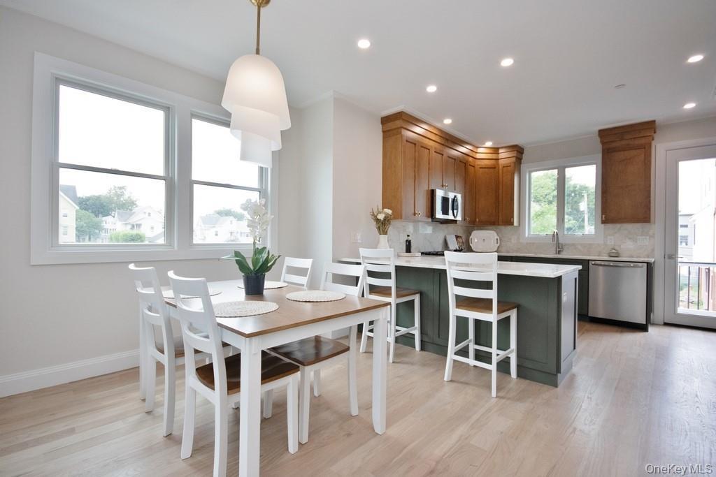 Dining area featuring light wood finished floors and recessed lighting