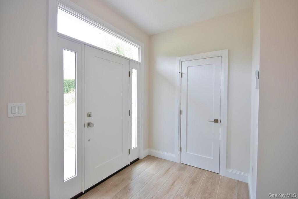 Foyer with light wood-style floors.