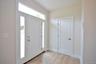 Foyer with light wood-style floors.