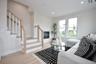 Living area featuring light wood-style floors, recessed lighting, a high end fireplace, and stairs