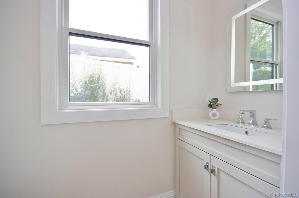 1/2 bath featuring vanity.