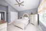 Bedroom with lofted ceiling, light wood-type flooring, a closet, and ceiling fan