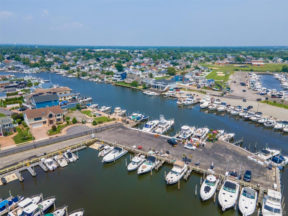 Bird's eye view of numerous boat docks and a nearby body of water