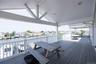 Wooden terrace featuring outdoor dining space, a water view, and a residential view