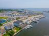 Drone / aerial view of numerous boat docks and a nearby body of water