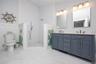 Bathroom featuring double vanity and a walk in shower