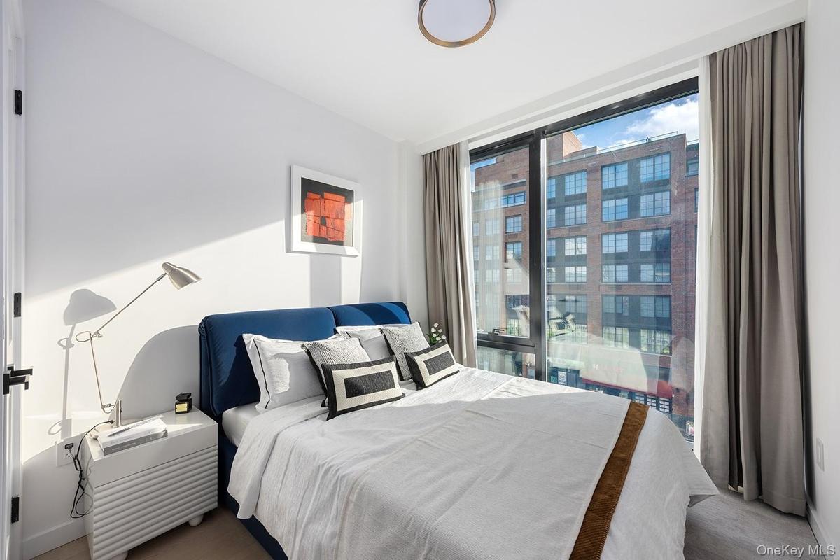 Bedroom featuring a wall of windows
