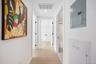 Corridor with electric panel, light wood-type flooring, and recessed lighting