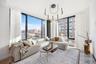 Living room featuring expansive windows, a chandelier, and a city view